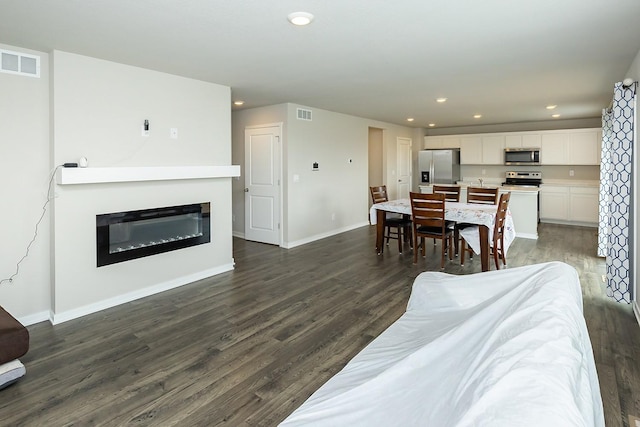 living room with dark hardwood / wood-style floors