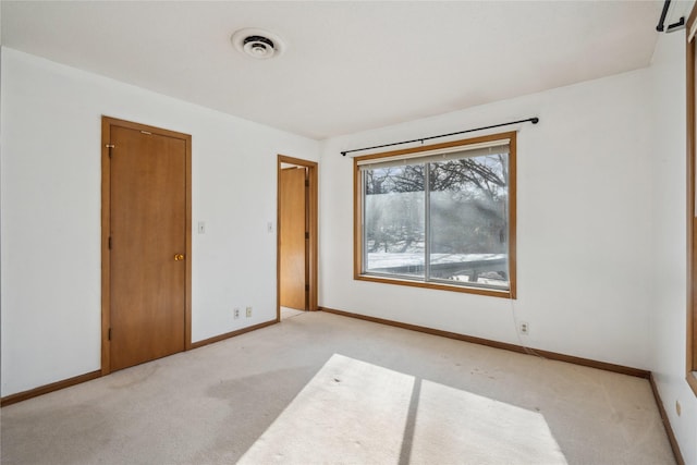 unfurnished bedroom with light carpet