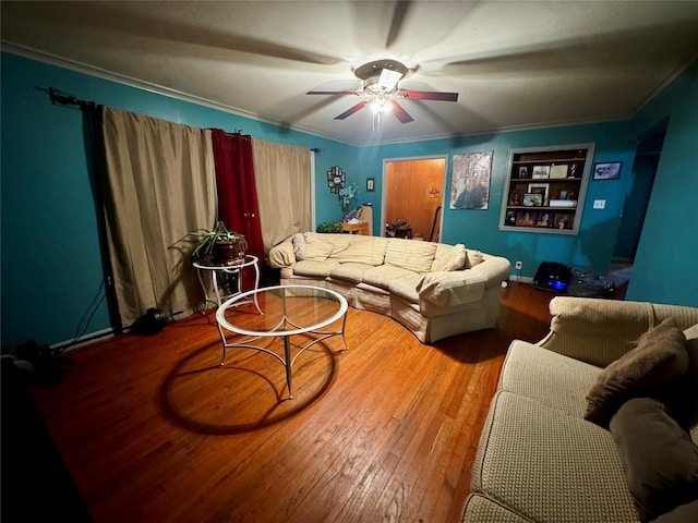 living room with crown molding, ceiling fan, and hardwood / wood-style flooring