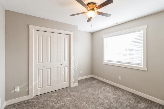 unfurnished bedroom with light carpet, ceiling fan, and a closet