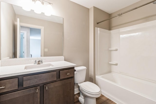 full bathroom featuring shower / bath combination, wood-type flooring, vanity, and toilet