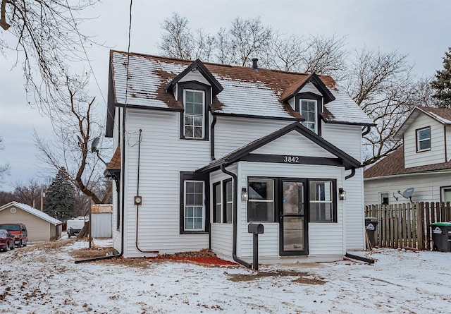 view of snow covered back of property