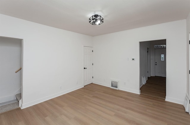 empty room with light hardwood / wood-style flooring