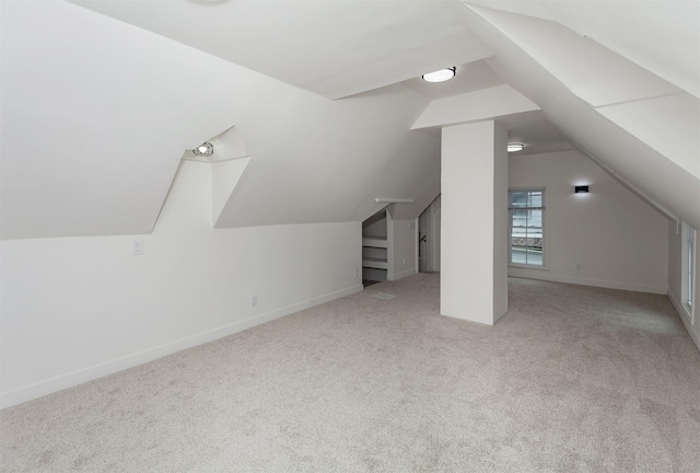 additional living space with lofted ceiling and light colored carpet