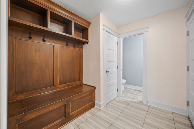 mudroom with a textured ceiling