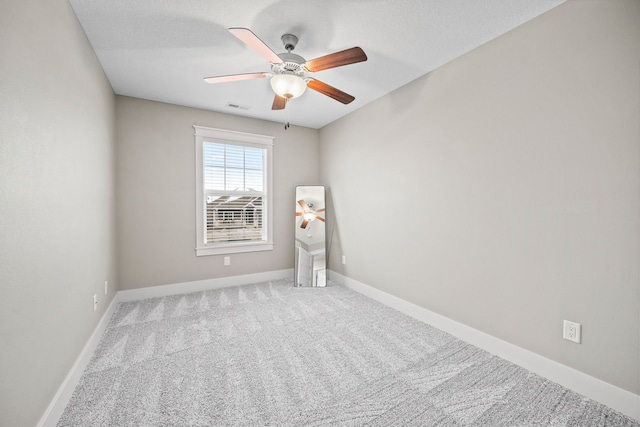 unfurnished room featuring carpet floors, a textured ceiling, and ceiling fan