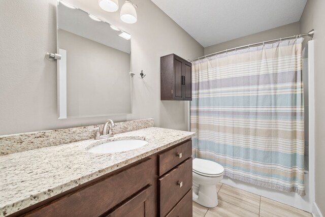 bathroom featuring walk in shower, vanity, and toilet