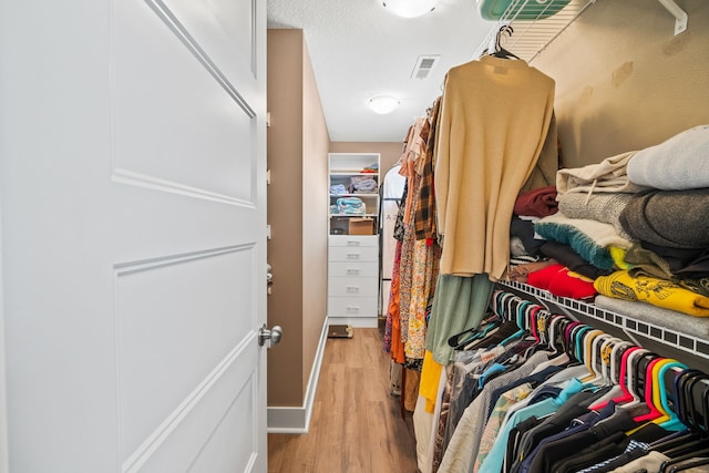 spacious closet with light hardwood / wood-style floors