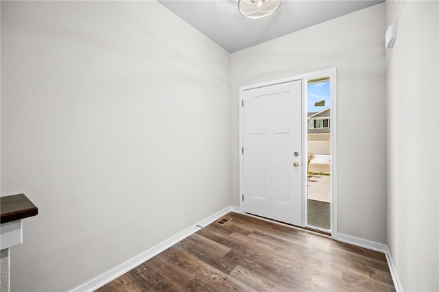 entryway with dark hardwood / wood-style flooring