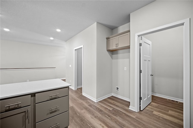 kitchen featuring gray cabinets and dark hardwood / wood-style flooring