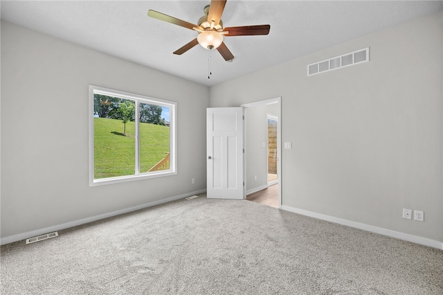 spare room with carpet floors and ceiling fan