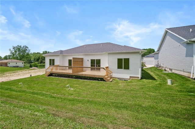 rear view of property with a deck and a lawn