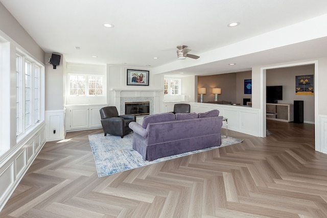 living room with a high end fireplace and light parquet floors