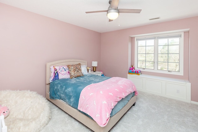 bedroom featuring light colored carpet and ceiling fan