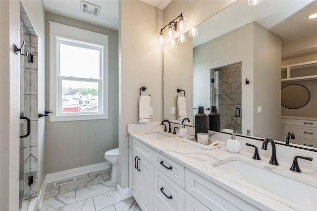 bathroom with toilet, vanity, and walk in shower