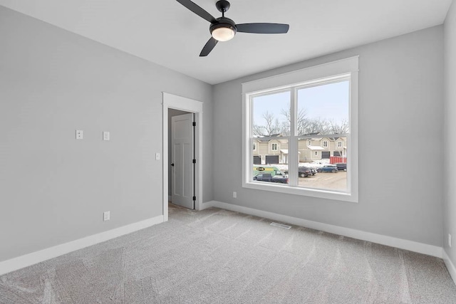 unfurnished room featuring light colored carpet and ceiling fan