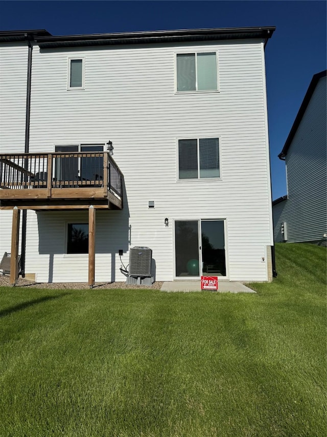 back of house featuring central AC, a yard, and a deck