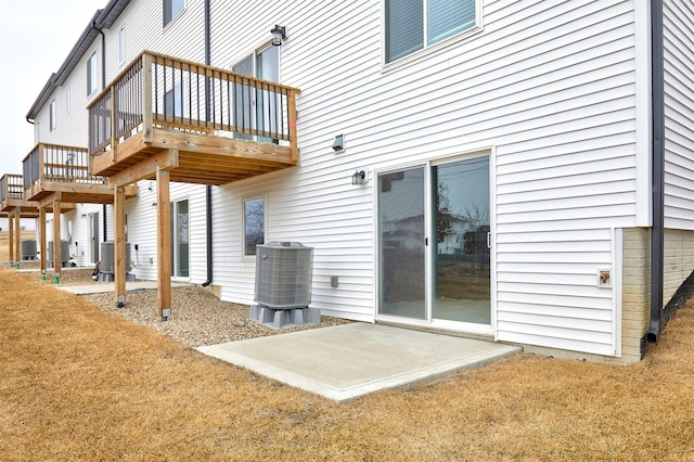 rear view of property with a patio, a yard, and central air condition unit