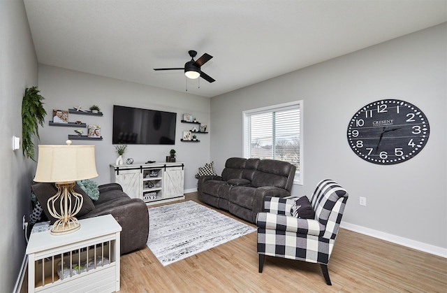 living room featuring hardwood / wood-style floors and ceiling fan