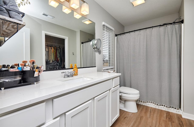 bathroom featuring vanity, hardwood / wood-style floors, and toilet