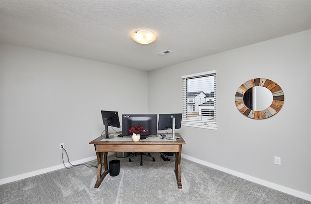 office featuring carpet floors and a textured ceiling