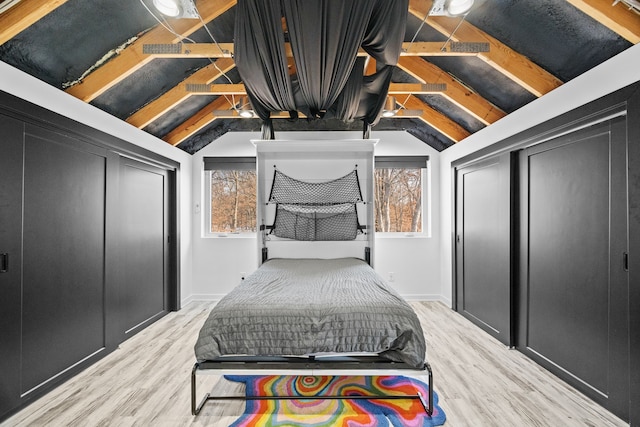 bedroom featuring vaulted ceiling and light hardwood / wood-style flooring