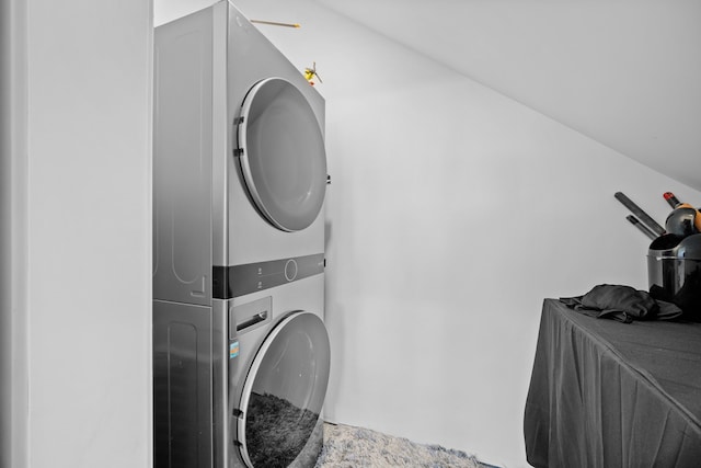 laundry area featuring stacked washer / drying machine