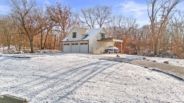 view of snow covered exterior with a garage