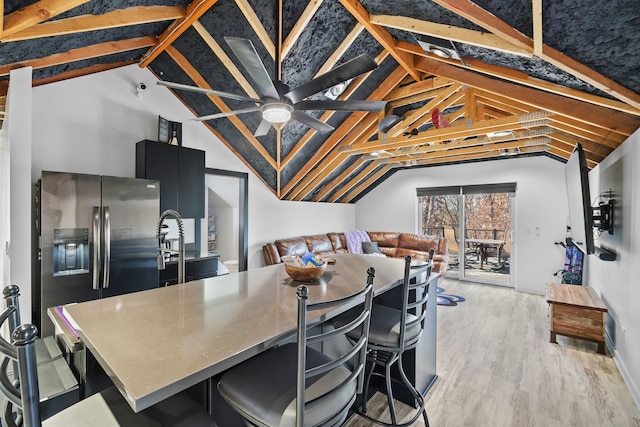 dining area with lofted ceiling and light hardwood / wood-style flooring