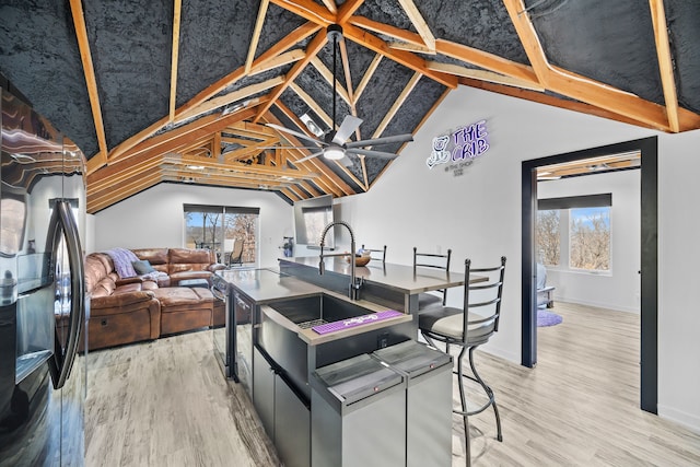 kitchen featuring hardwood / wood-style flooring, a wealth of natural light, and stainless steel fridge with ice dispenser