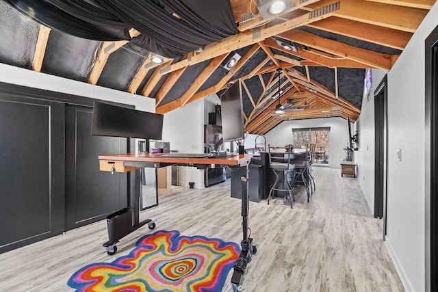 recreation room with vaulted ceiling and light hardwood / wood-style floors