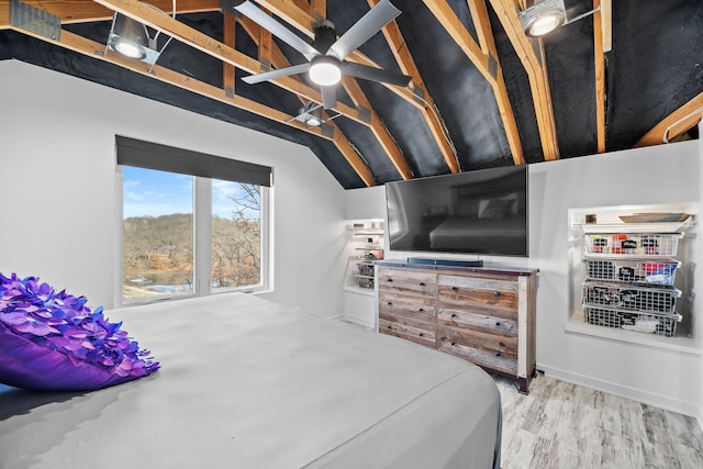 bedroom with hardwood / wood-style flooring, ceiling fan, and lofted ceiling