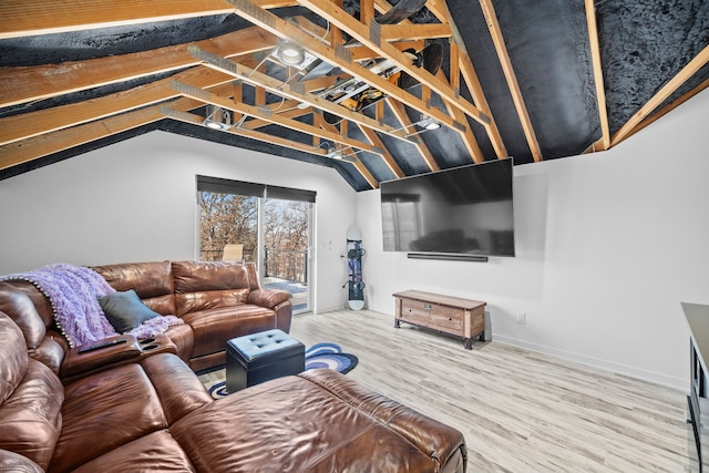 living room featuring lofted ceiling and hardwood / wood-style floors