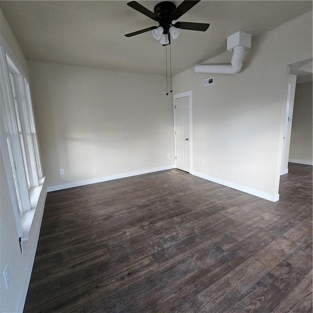 empty room featuring ceiling fan, lofted ceiling, and dark hardwood / wood-style floors