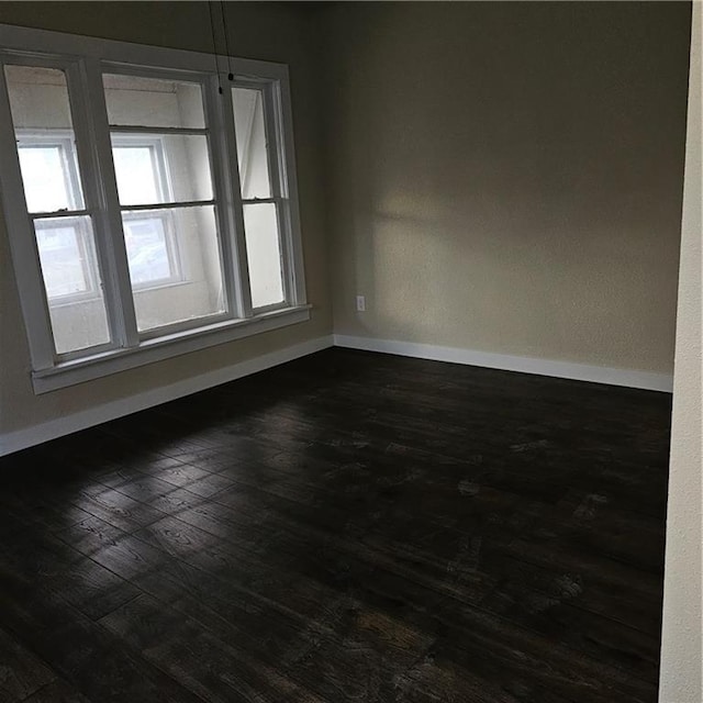 unfurnished room featuring dark hardwood / wood-style floors