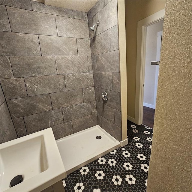 bathroom with a tile shower