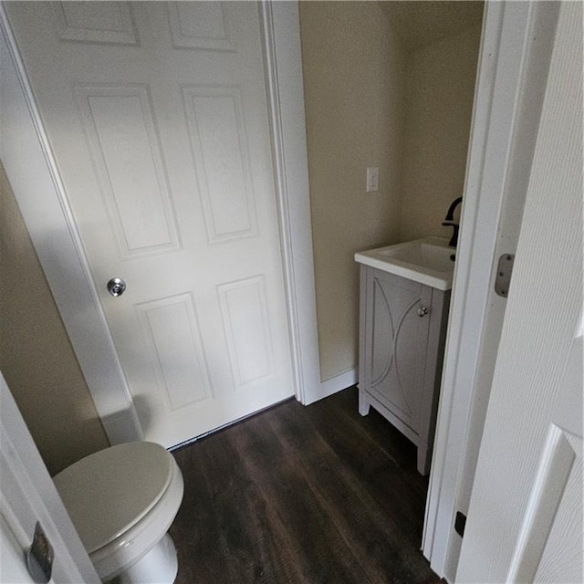 bathroom featuring hardwood / wood-style flooring and toilet