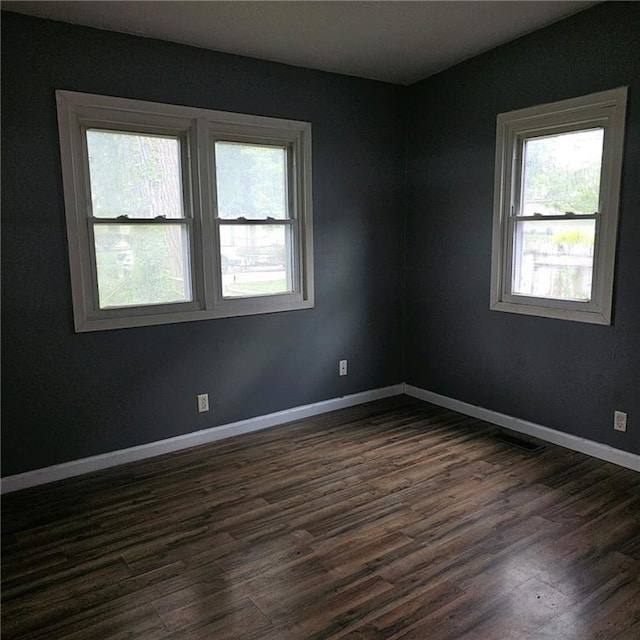 empty room with dark hardwood / wood-style floors