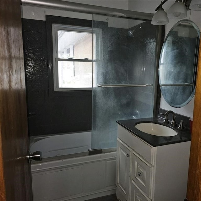 bathroom featuring vanity and shower / bath combination with glass door