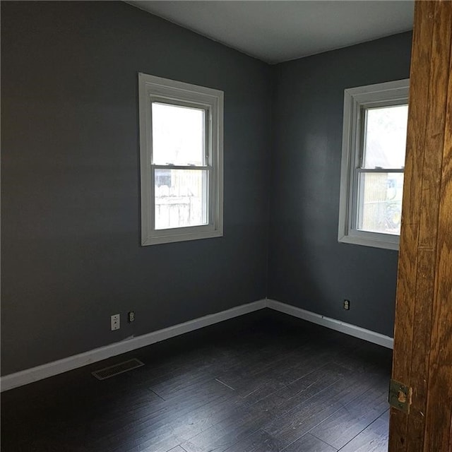 empty room with dark wood-type flooring