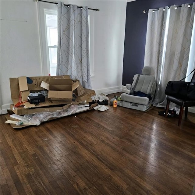 sitting room with hardwood / wood-style flooring and a barn door