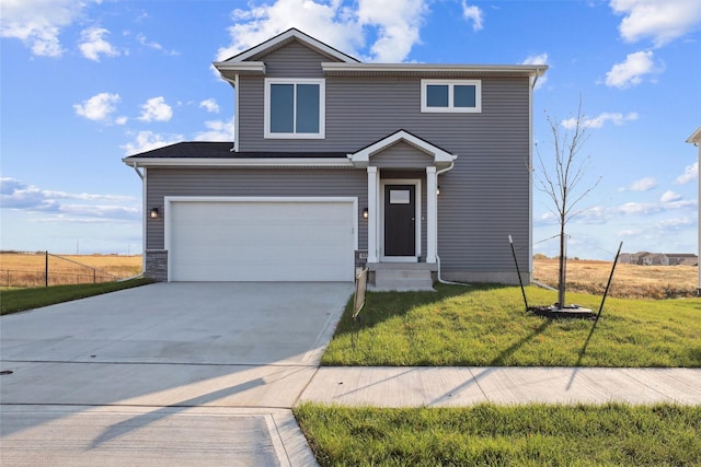 view of front of property featuring a garage and a front yard