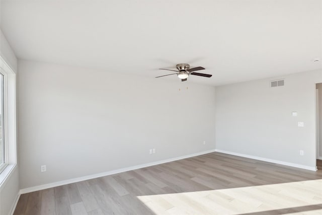 empty room featuring light hardwood / wood-style flooring and ceiling fan