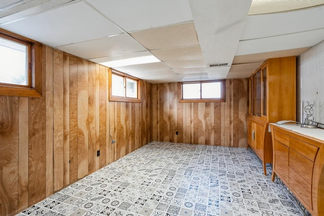 basement featuring wood walls