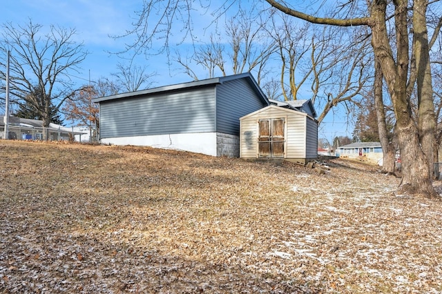 view of property exterior featuring a shed