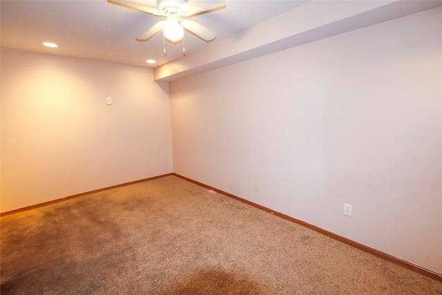 carpeted spare room featuring ceiling fan