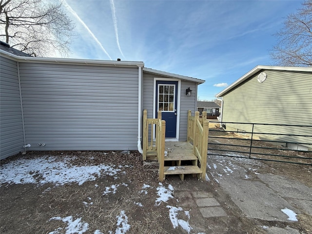 view of snow covered rear of property