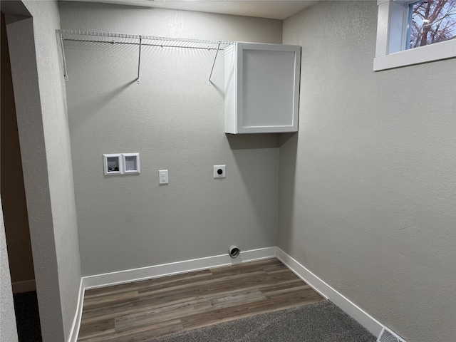 washroom with electric dryer hookup, hookup for a washing machine, and dark hardwood / wood-style floors