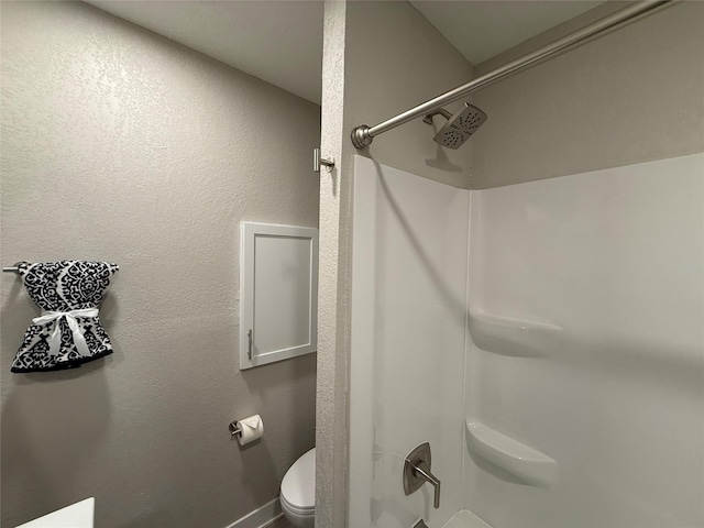 bathroom with toilet and walk in shower