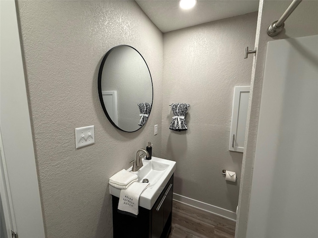 bathroom featuring vanity and hardwood / wood-style floors